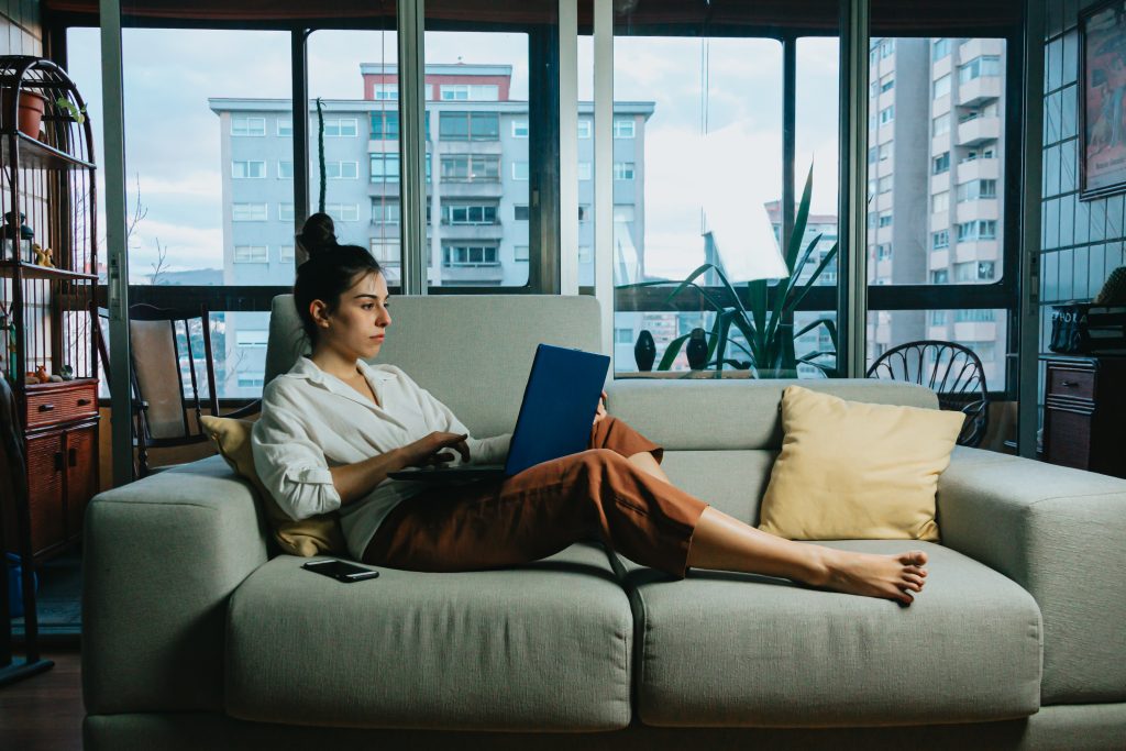 laptop-lying-working-computer-woman-apartment-couch