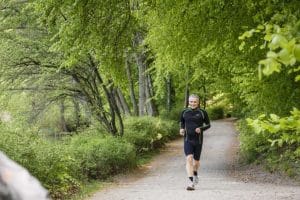 man-running-path-forest-hardwood-green