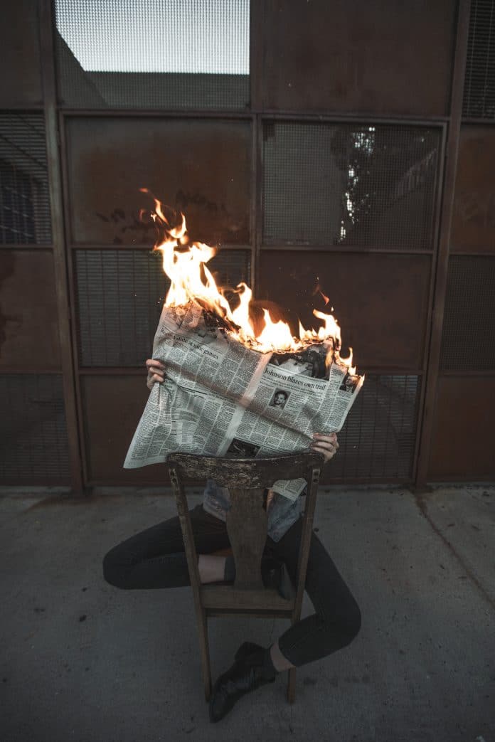 jeremy bishop-burning newspaper