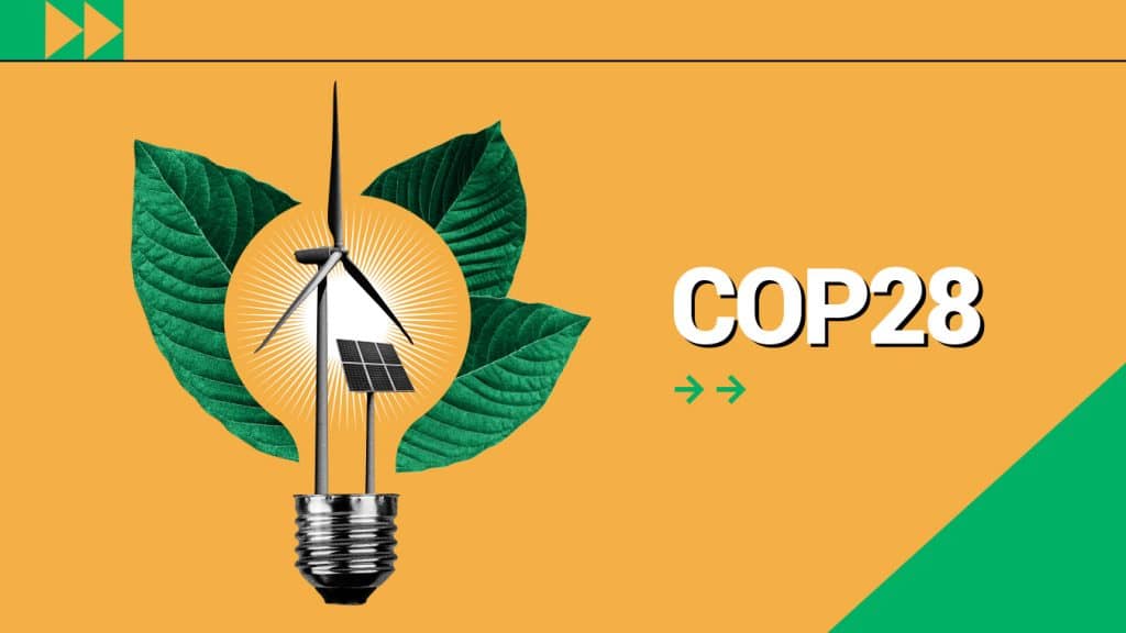 Orange sign with COP28 logo and green leafs and windmill