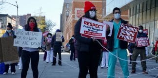 Nurses and healthcare workers outside at a hospital in New York City demand better protection against the COVID-19 virus.