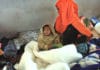 A Somali woman sits with her one-year-old child, in the Ganfoda Detention Centre near Benghazi, after fleeing violence in her country and illegally entering Libya.