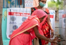 A woman in Gujarat, India, is educated on the benefits of handwashing during the COVID-19 pandemic.
