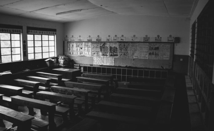Photo of empty classroom, by Mwesigwa Joel on Unsplash