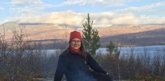 Elin Marakatt is Sami sitting in front of a fire