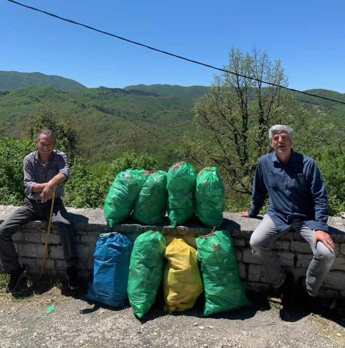Dimitrios and friend Kostas with bags full of plastic waste