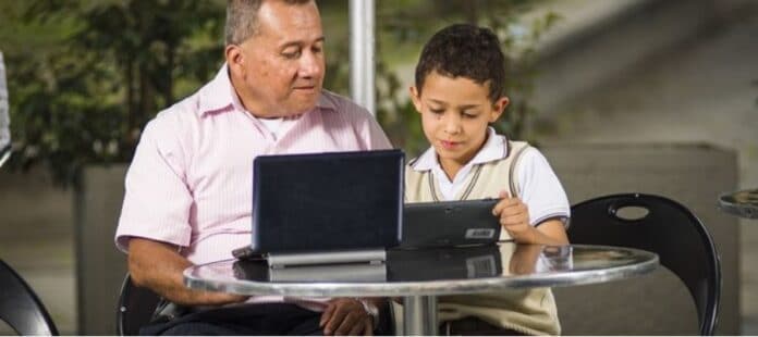Father and son in front of laptop