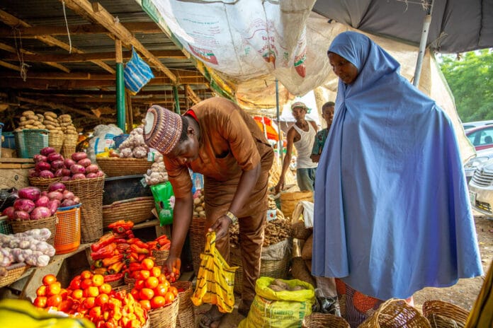 Woman buying food at yankaba market in NIgeria