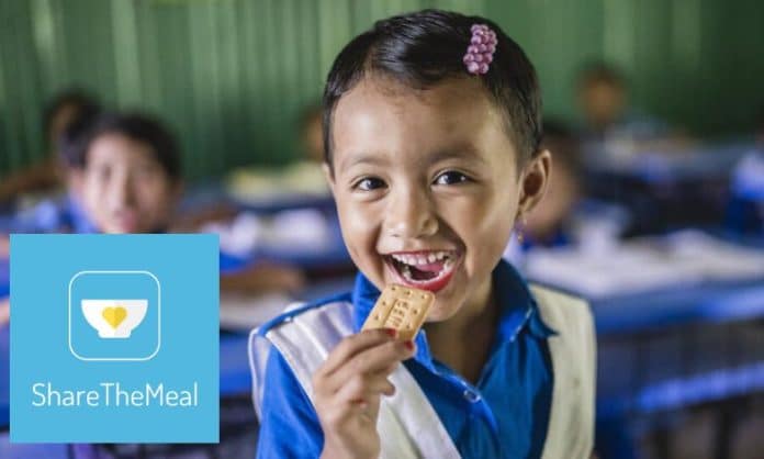 Girl eating a biscuit provided by WFP ShareTheMeal © WFP/Sayed Asif Mahmud
