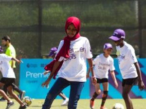 Girl playing football as part of British Council Premier Skills programme