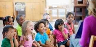 children listening to a teacher, classroom