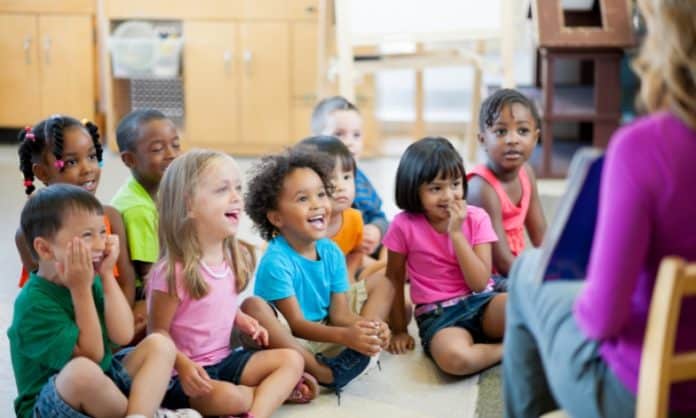 children listening to a teacher, classroom