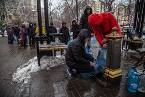 Kyiv, Ukraine: People queue at drinking fountains with buckets to get water the next day after attacks on critical infrastructure in November 2022.