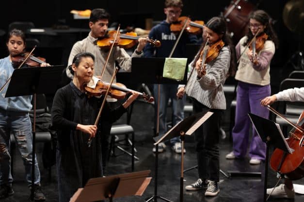 The UN Messenger of Peace, violinist Midori Goto, practicing with young Afghan students during an artistic residency in Braga, Portugal