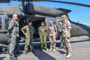 Gjerde and colleagues in front of a helicopter