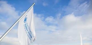 Flag above Lake Geneva sporting the UN Human Rights office's logo