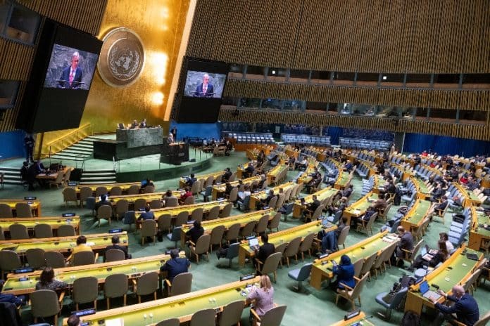 UN Secretary-General António Guterres (on screens) briefs the 54th plenary meeting of the General Assembly on the work of the organization and his priorities for 2024.