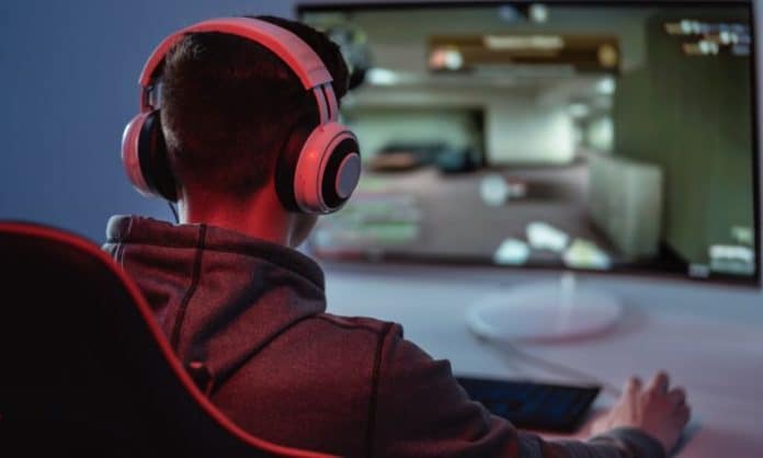 Video gamer playing with his headset on