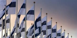 Several Finnish flags, picture taken against the sky