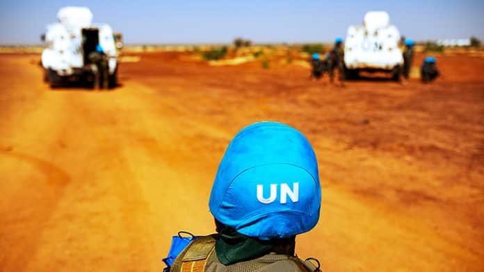 UN Peacekeeper monitoring desert road