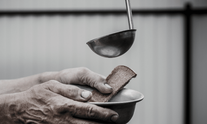 adding soup to a bowl held by an elderly person