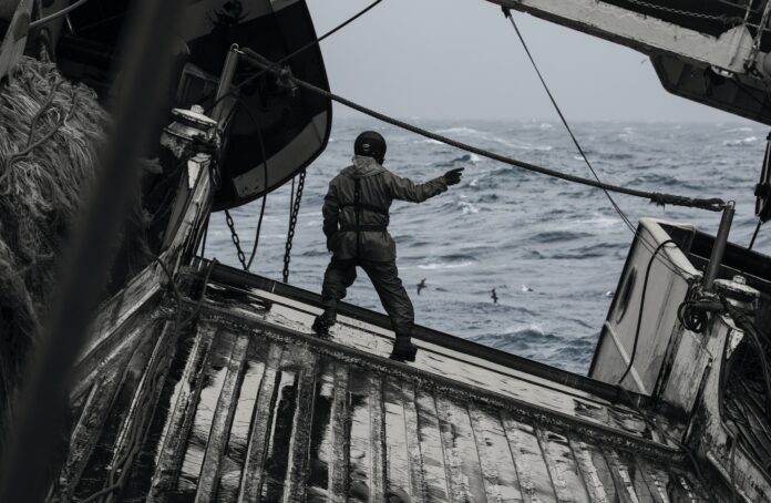 Un contramaestre dirigiendo la maniobra a pie de rampa del barco