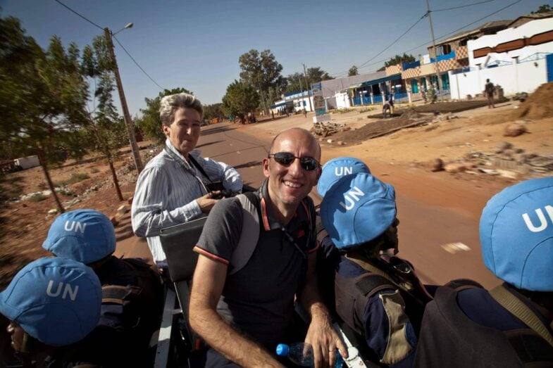 Olivier Salgado, chargé de communication de la mission de paix au mali, assis sur moto avec des casques bleus et une journaliste