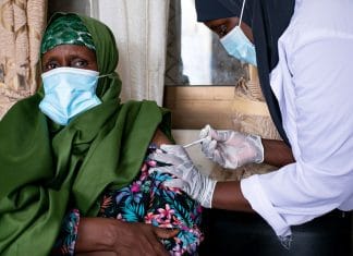 A woman receives a dose of a COVID-19 vaccine at a health clinic in Garowe, Somalia.
