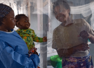A plastic sheet separates a mother from her son at an Ebola treatment centre in North Kivu province, eastern DRC.