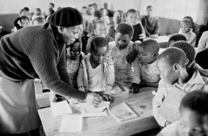 Young school children in a classroom in the village of Cross Roads, South Africa