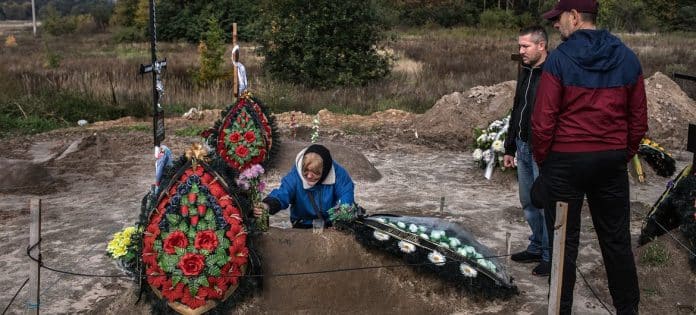 A mother in Bucha, Ukraine, buries her son