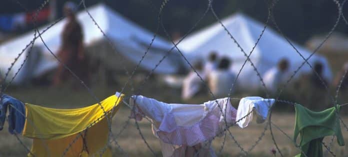 Filo spinato intorno a un campo per circa 25.000 sfollati di Srebrenica. La recinzione era lì per impedire alle persone di vagare nei campi circostanti che potevano essere stati minati. (Foto del 1995)