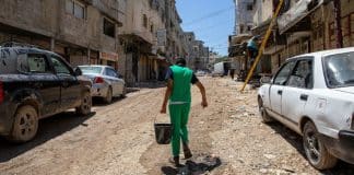 A person carries water through the streets in a West Bank town. The situation there is gradually worsening.