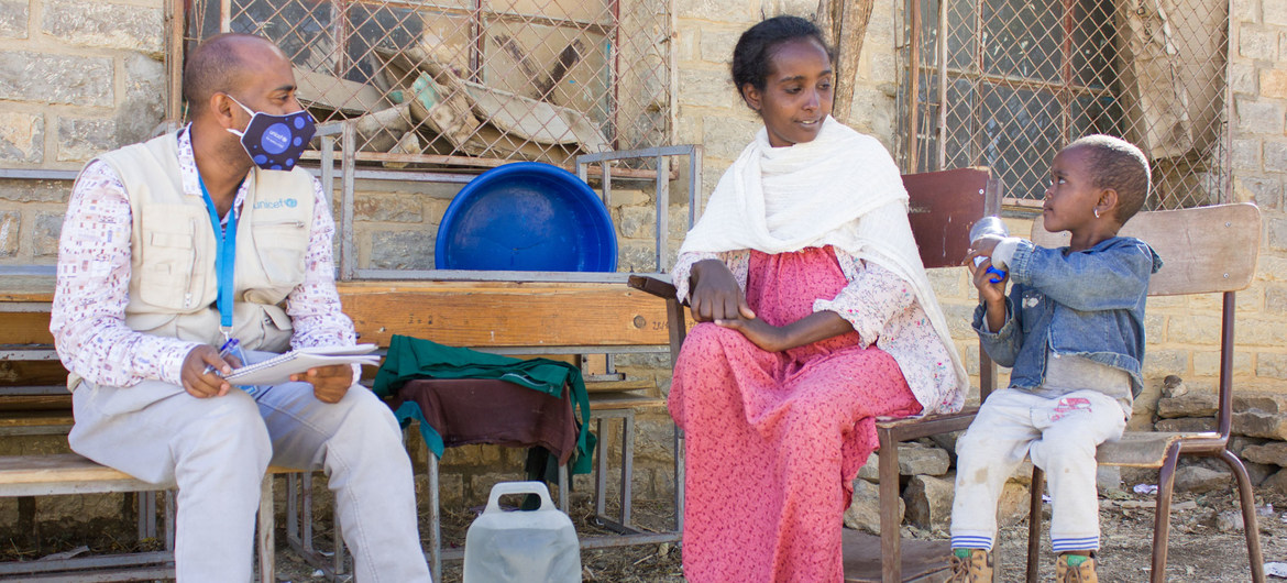 Uma mãe deslocada da zona noroeste de Tigray fala com um funcionário humanitário na cidade de Mekelle.