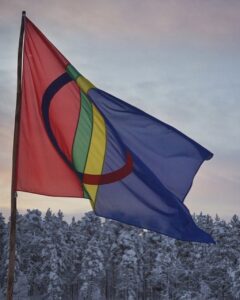 Samiska flaggan, snötäckta granar, solnedgång