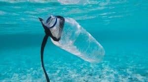 En plastflaska som flyter under vattenytan