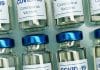 Vaccinflaskor med texten covid 19