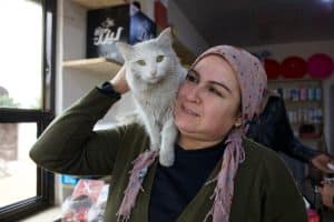 En kvinna med en katt på axeln